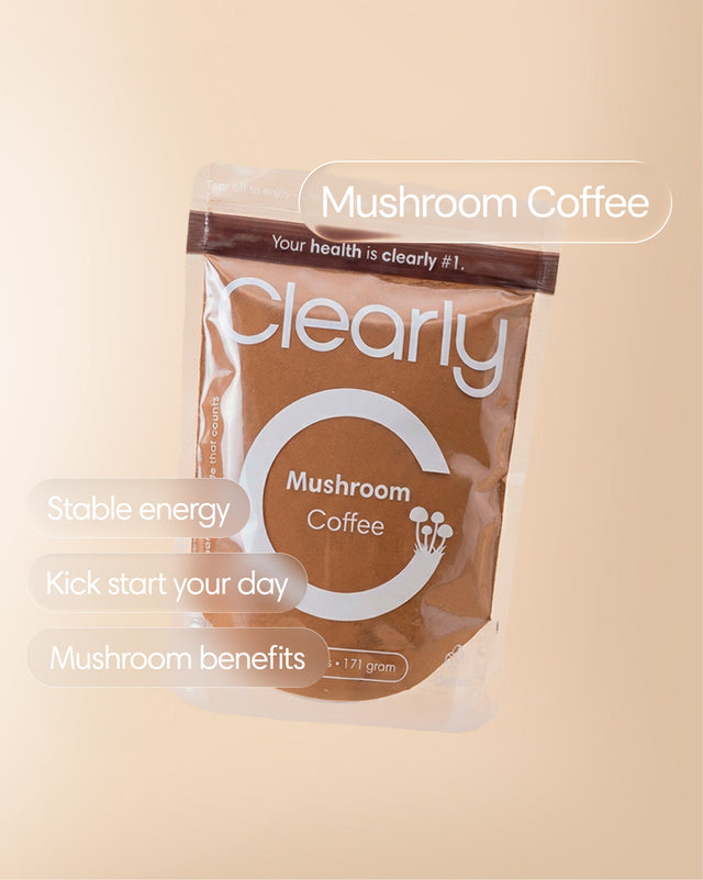 Clearly Mushroom Coffee in a clear glass mug showing a rich, dark coffee with mushroom extract, steam rising from the hot beverage.